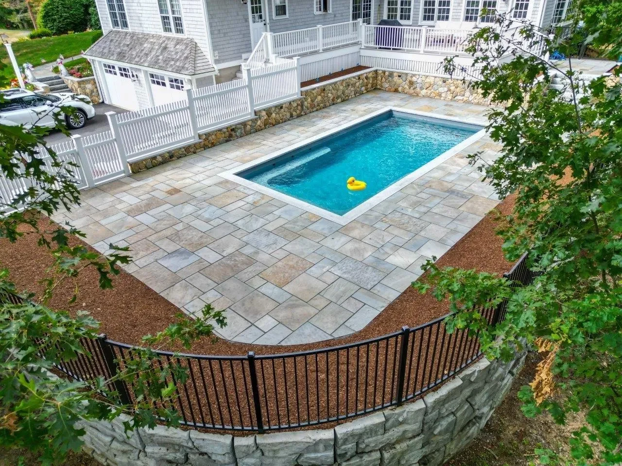 Bluestone pool patio with Boston Blend stone veneer retaining wall