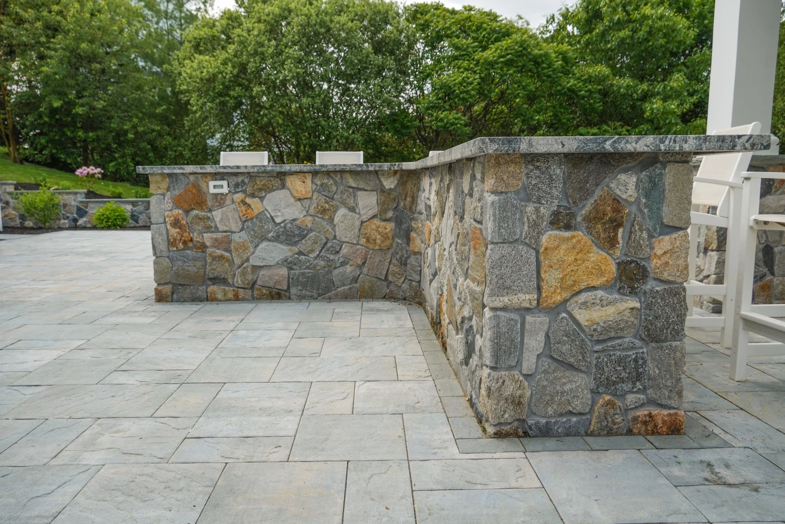 Stone veneer outdoor kitchen bar detail