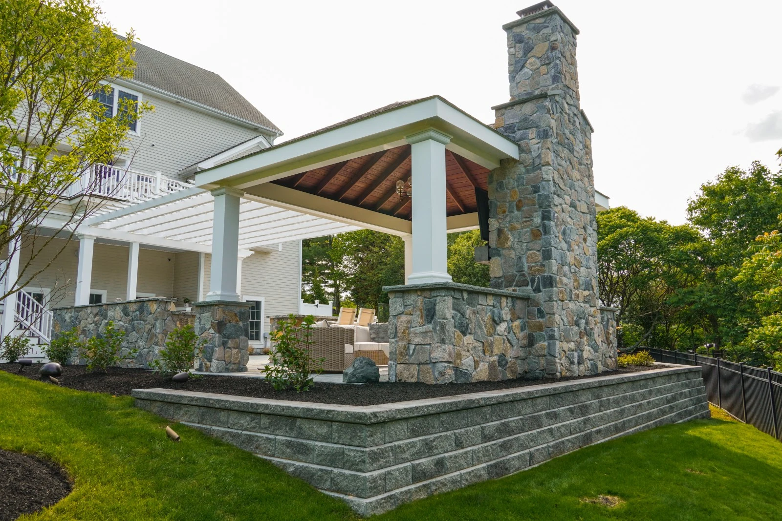 Covered pavilion with stone fireplace in Hingham project