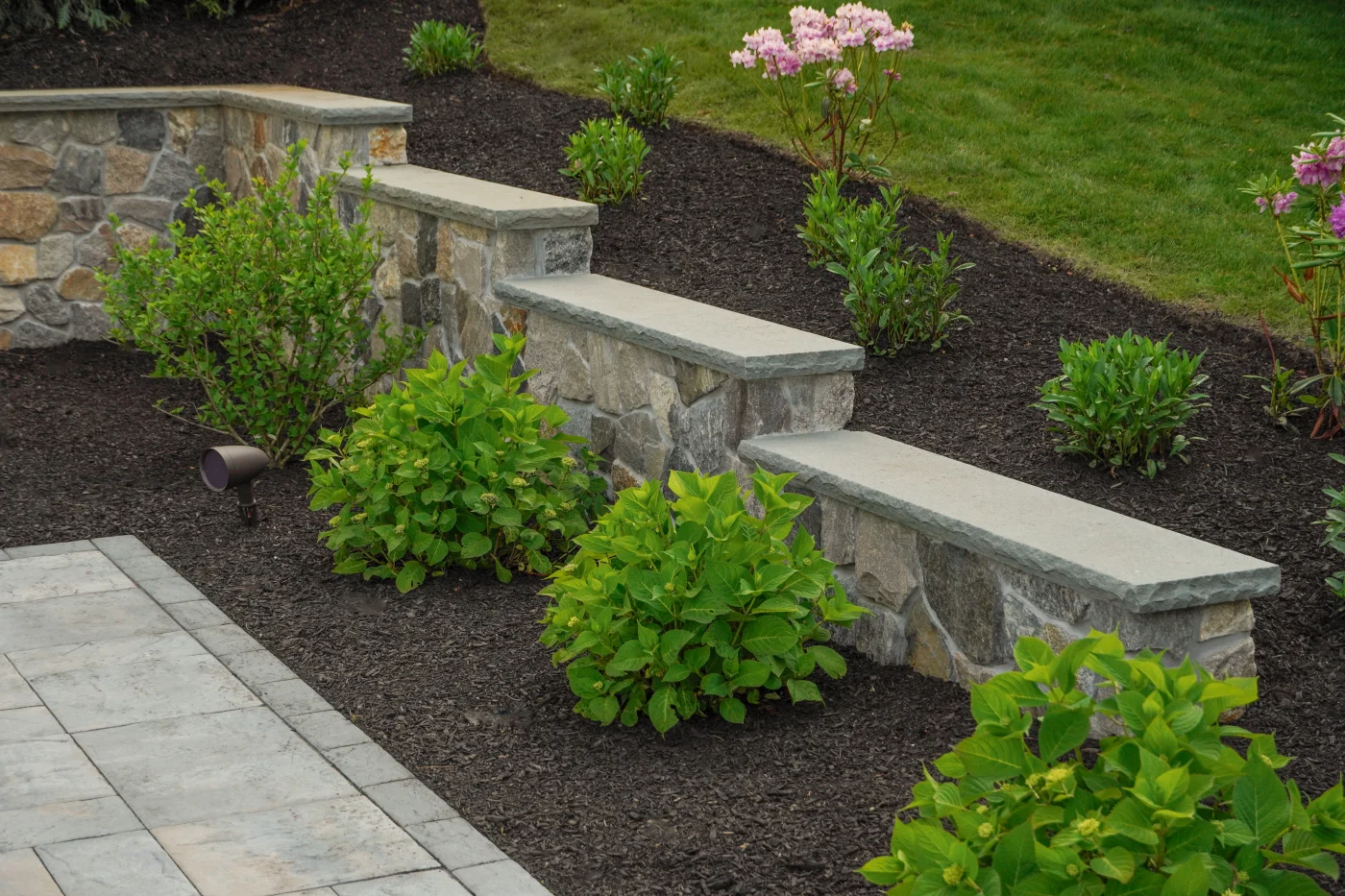 Stone steps and retaining wall with landscape lighting
